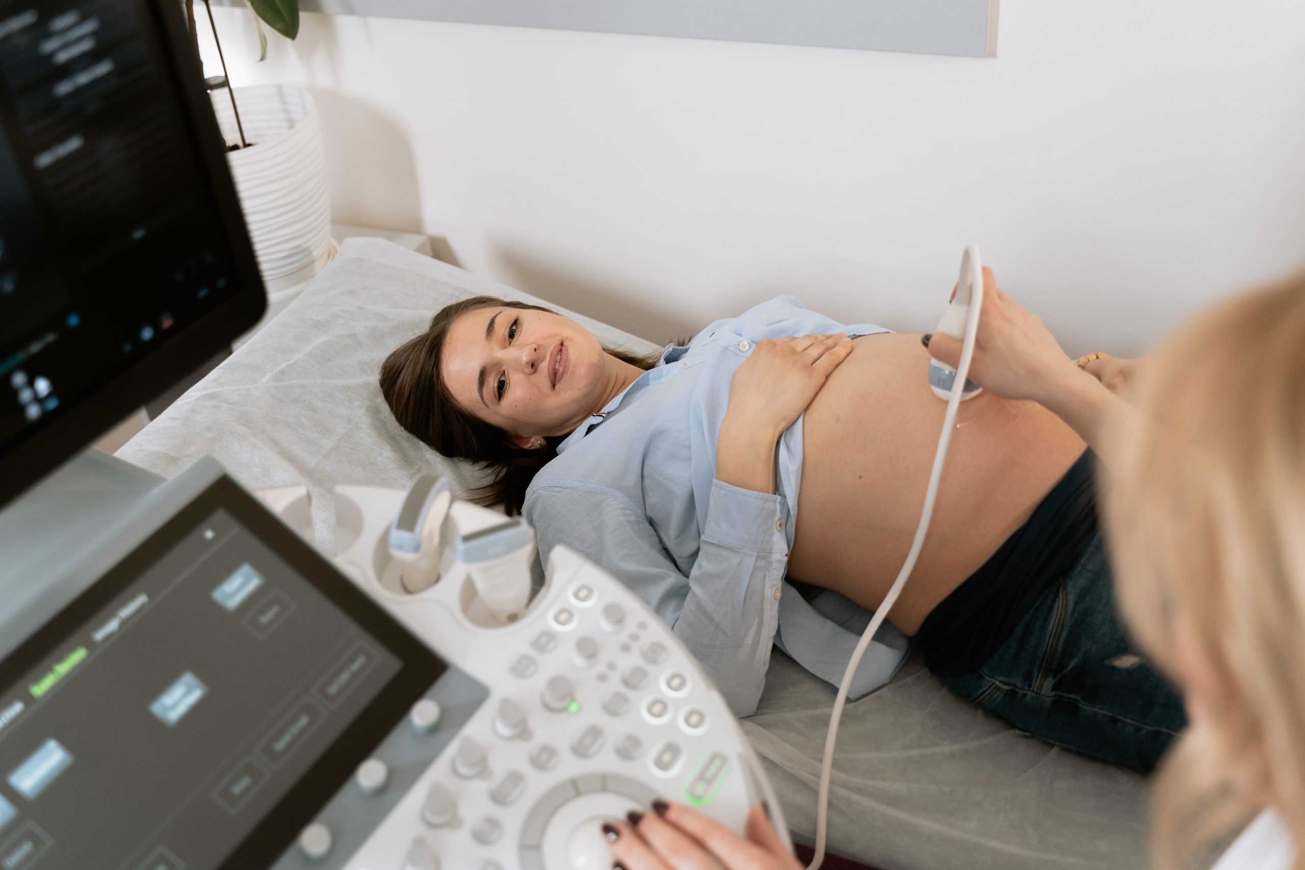 photo of a gynecologist doing an ultrasound on a pregnant woman
